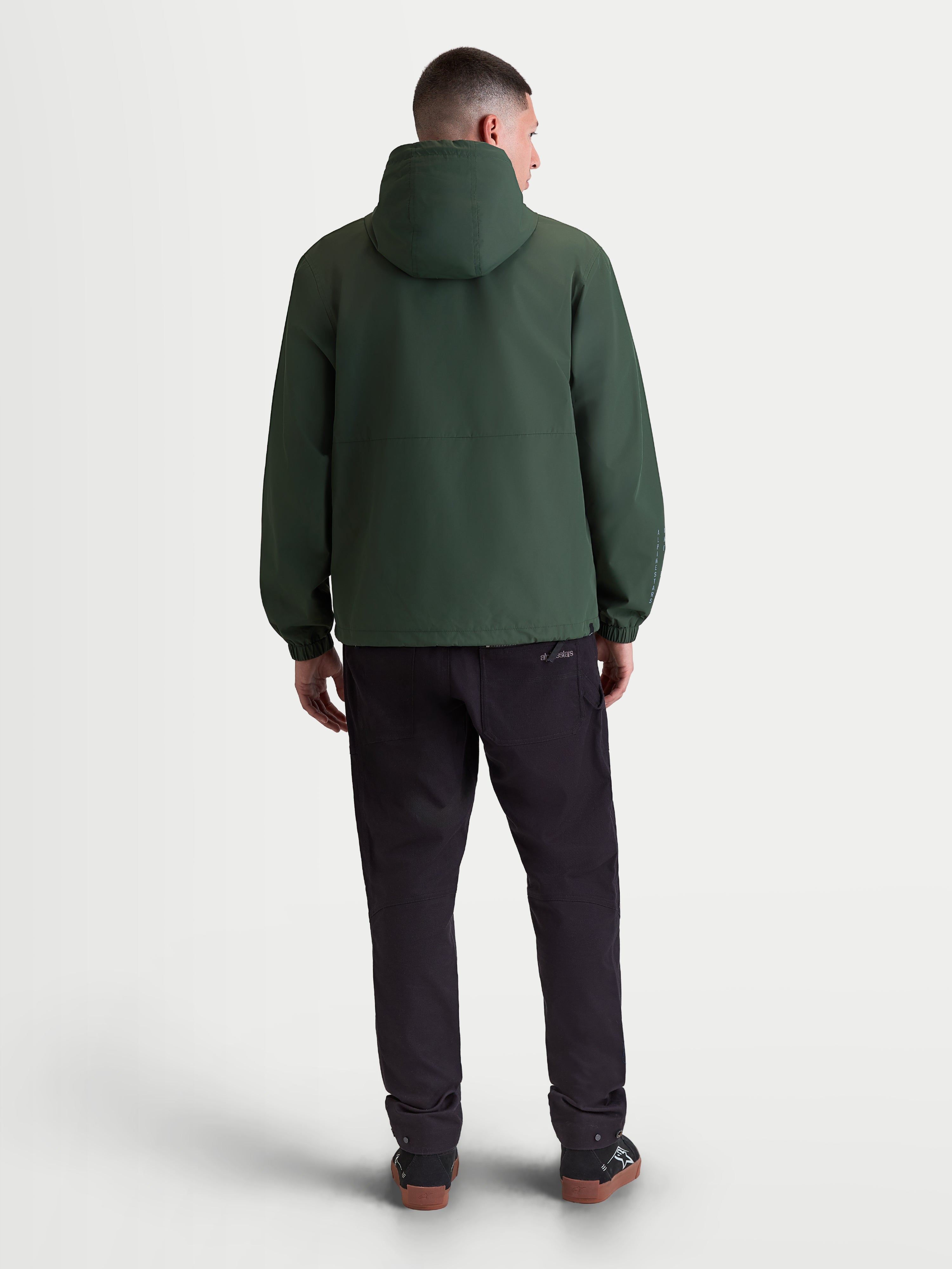 Alpinestars Speeder Resolve windbreaker jas, lichtgewicht heren-sportswear, groen, winddicht textiel, achteraanzicht met capuchon en elastische manchetten.