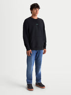 Alpinestars Guise Oversized Crew, premium sportswear pullover voor heren, relaxte oversized pasvorm, zwart met teal geborduurd logo op de borst, voorzien van kangoeroezak en geribde boorden, zachte fleece van katoen en gerecycled polyester.