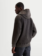 Alpinestars Infinite Washed Oversized Hoodie, Men's Sportswear Pullover in Washed Black, Snow-Wash Finish Fleece, relaxed fit with self-lined hood and embroidered logo detailing, back view on model.