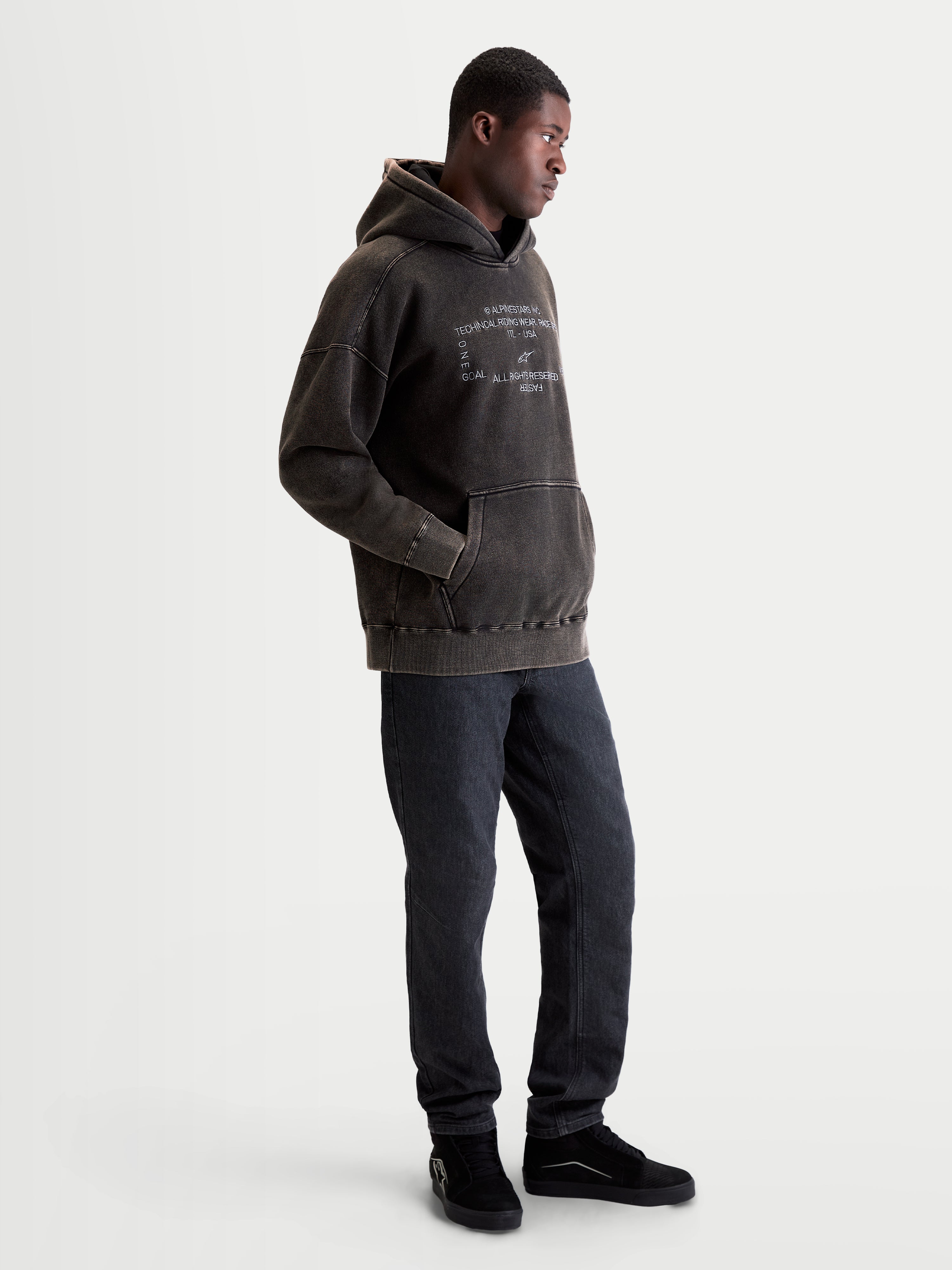 Alpinestars Infinite Washed Oversized Hoodie, casual sportswear pullover for men, Washed Black with snow-wash finish, featuring white embroidered logo graphics on the chest and a kangaroo pocket.
