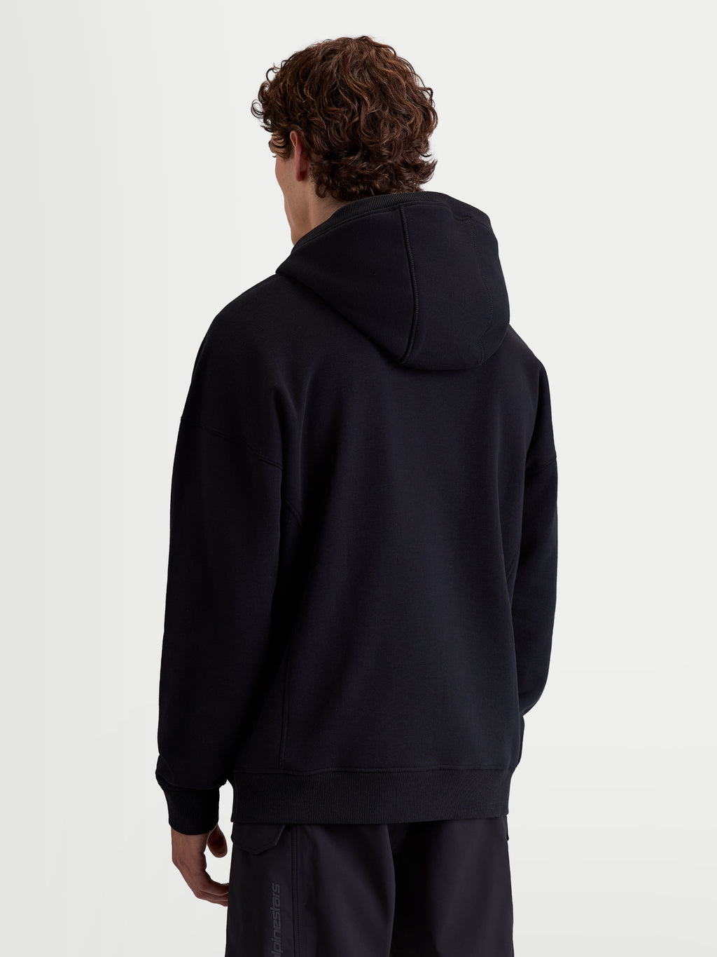 Alpinestars Shaw Oversized Hoodie, sportswear-pullover voor heren en dames, zwart, achteraanzicht met relaxte oversized pasvorm, zachte fleece van katoen en gerecycled polyester met geribde boorden