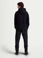 Alpinestars Shaw Oversized hoodie, zwarte casual sportswear-pullover, volledig achteraanzicht op model, relaxed silhouet met zelfgevoerde capuchon en geribde boorden, zachte fleece constructie.