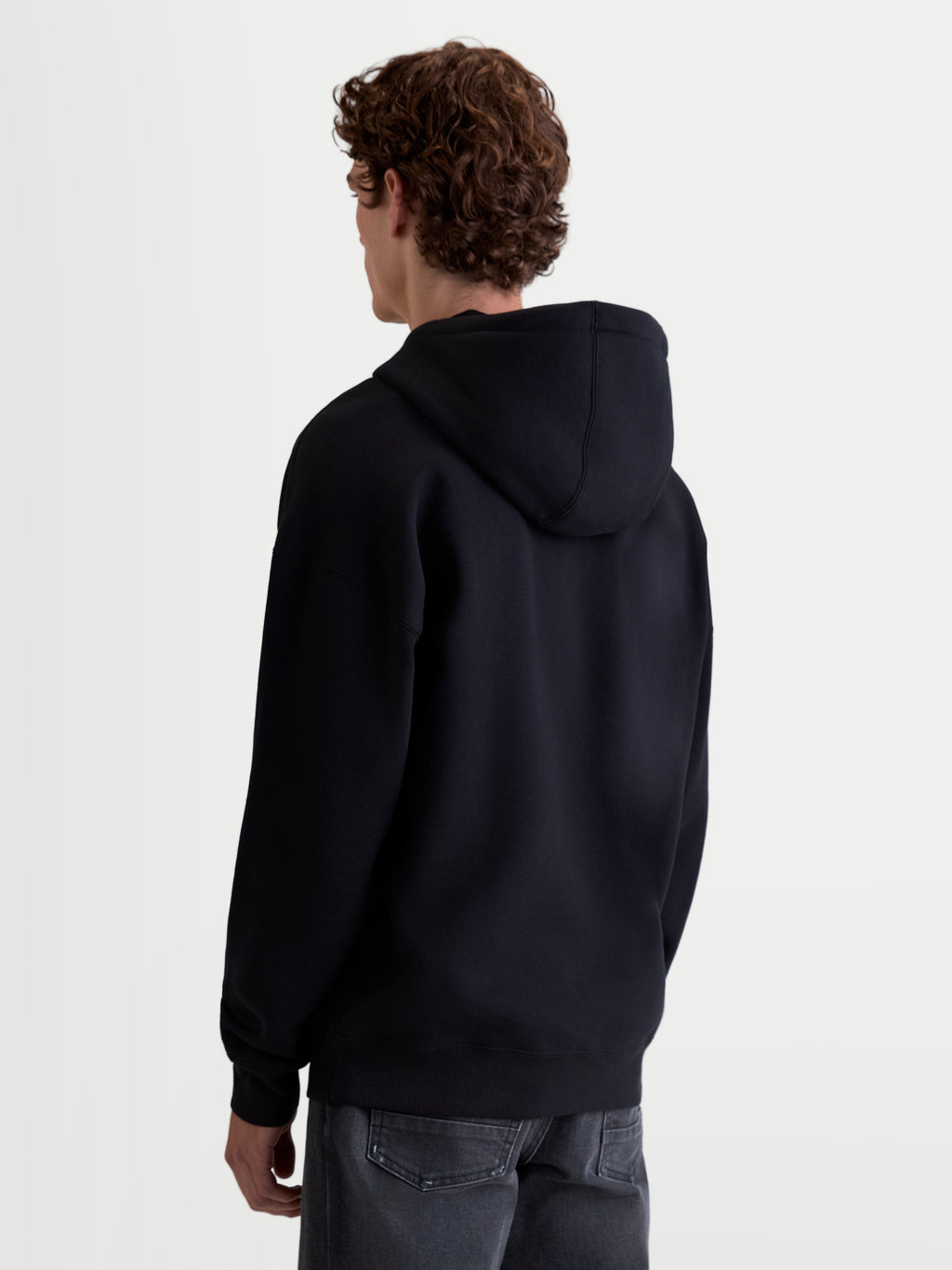 Alpinestars Prelude oversized hoodie, sportswearfleece pullover, unisex, zwart, achteraanzicht met een ontspannen silhouet, gevoerde capuchon en geribde zoom en manchetten voor een strakke afwerking.