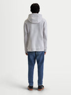 Alpinestars Prelude Oversized hoodie, heren-sportswear fleece-pullover in grijs, achterzijde op model toont de ontspannen pasvorm, gevoerde capuchon en geribde manchetten en zoom.