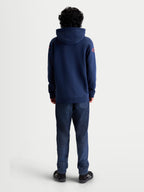 Alpinestars Velocifier Hoodie, sportswear pullover fleece, blauw met rode schouderlogo's, achteraanzicht op model, premium katoen en gerecycled polyester voor een casual off-bike stijl.