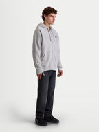 Alpinestars Entity Oversized Hoodie, Men's Sportswear Zip-Up Fleece, Cement Gray, featuring a relaxed fit, Vislon front zipper, self-lined hood, and kangaroo pocket. On-model shot showing chest and sleeve embroidery details, designed for casual lifestyle and motorsports enthusiasts.