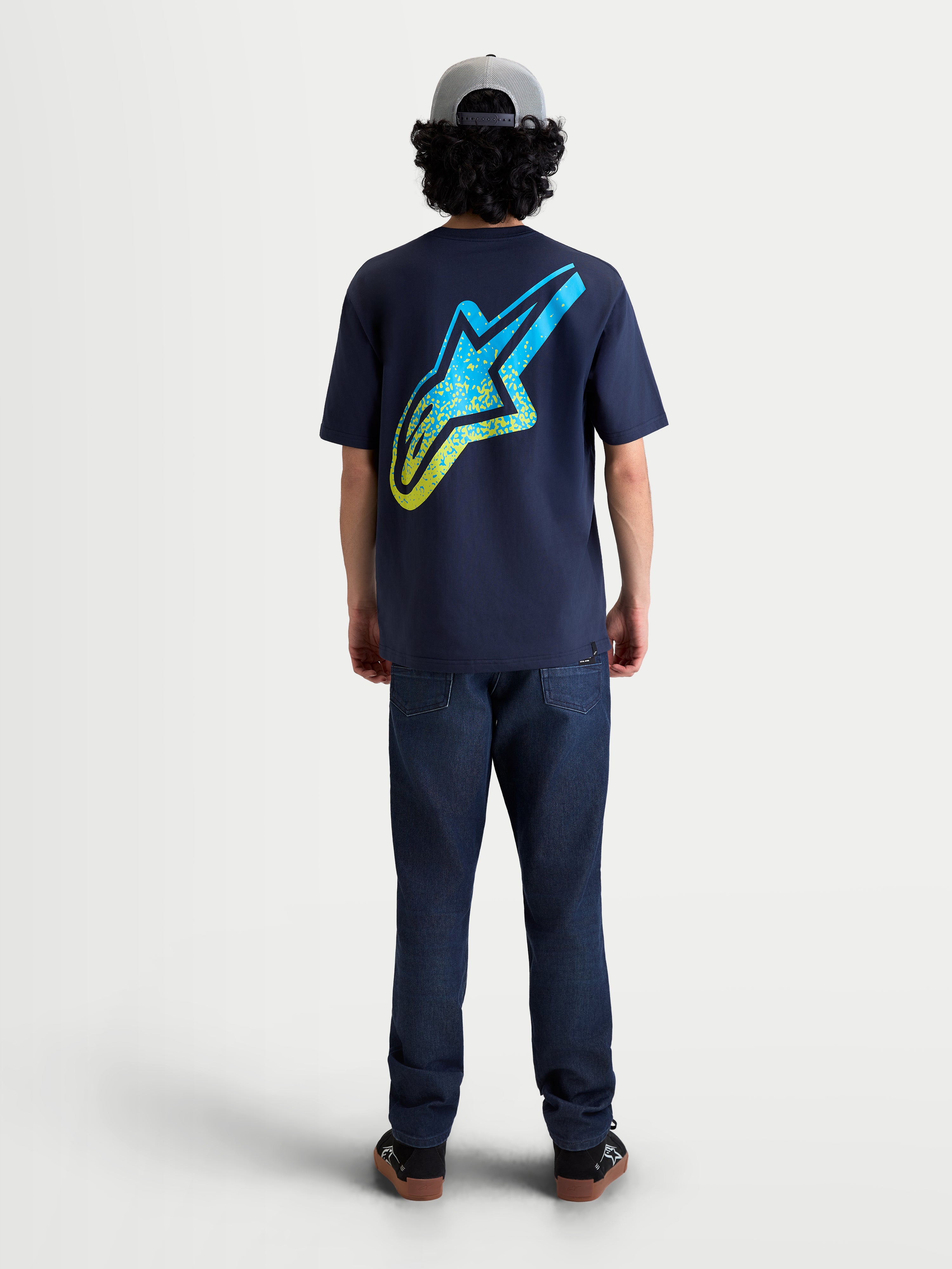 Alpinestars Meteor CSF Tee, Navy Blue Short Sleeve Sportswear T-shirt, back view on model, featuring a large yellow and cyan MX-inspired gradient Astars logo on the back, soft cotton-poly blend construction for casual everyday comfort.
