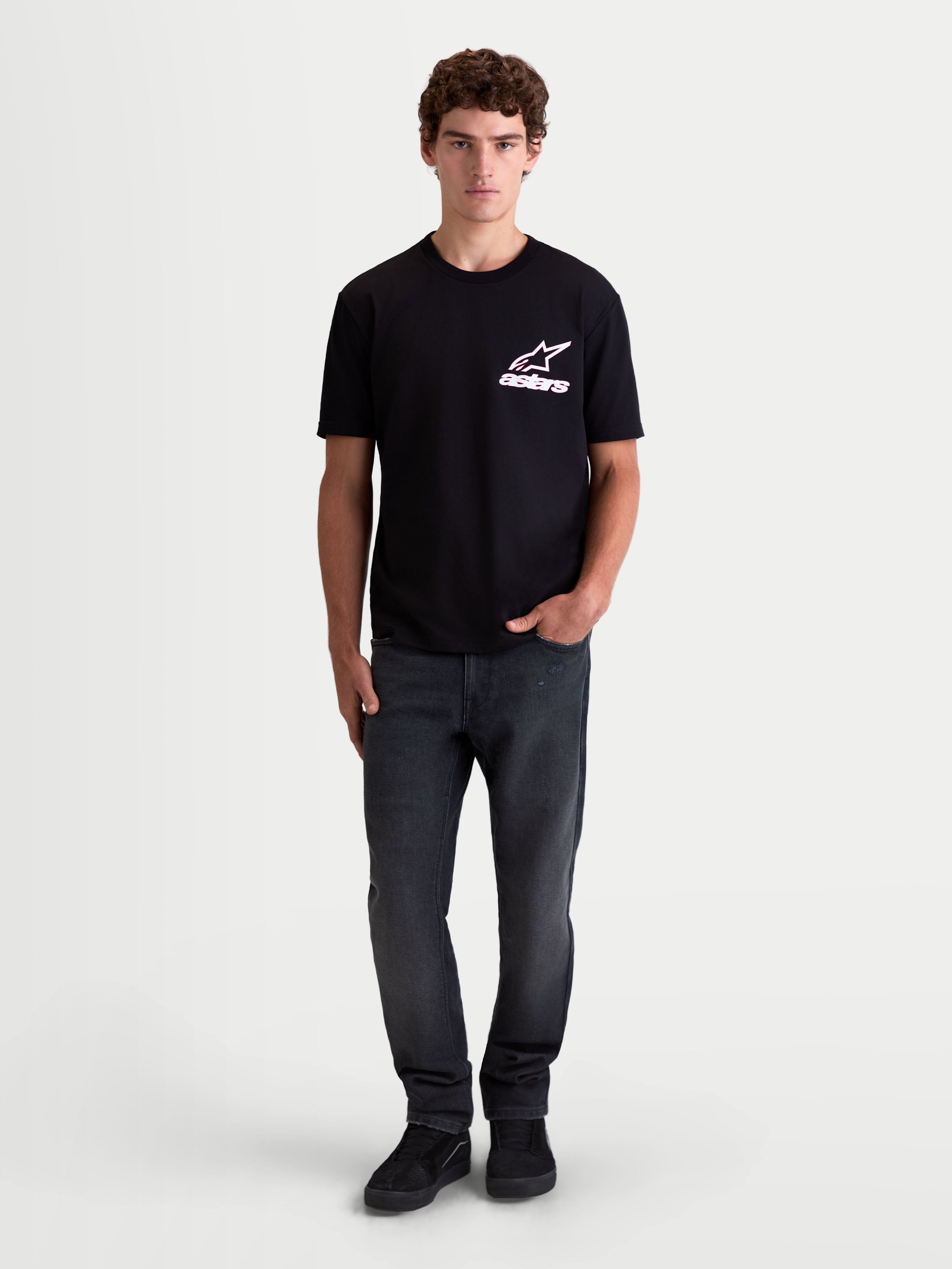 Alpinestars Lineout CSF t-shirt, heren-t-shirt met korte mouwen, zwart met wit en roze Astars-logo op de borst, op een model, zachte katoen-polyester mix, casual sportswear.