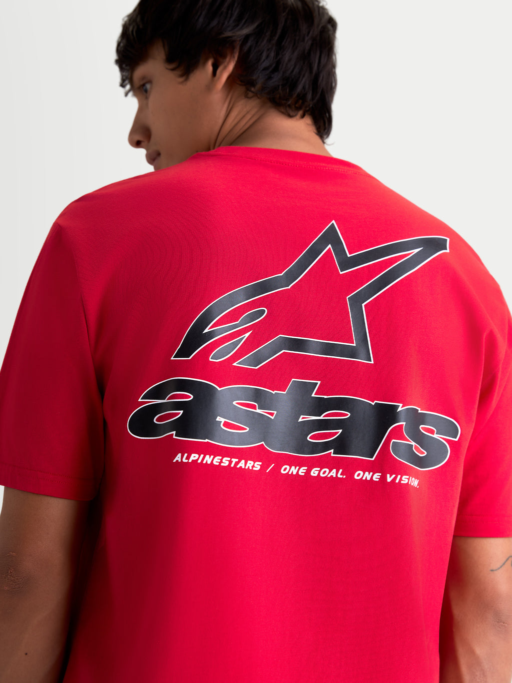 Alpinestars Lineout CSF t-shirt met korte mouwen, rood met zwart-witte graphics, achteraanzicht op model met groot Astars-logo en 'One Goal. One Vision.' tagline, zachte printafwerking, casual sportswear.
