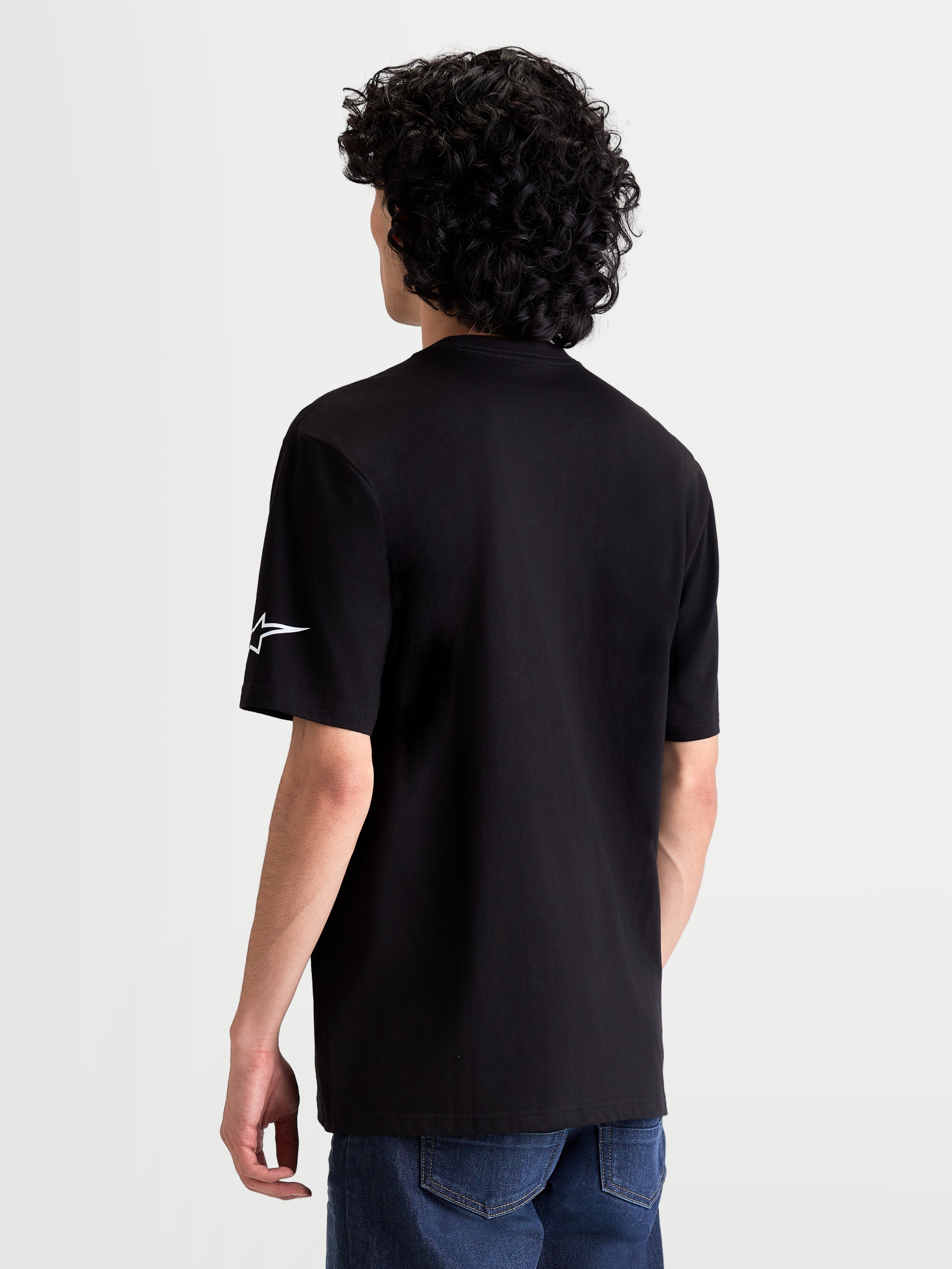 Alpinestars Race Wordmark CSF Tee, Casual Sportswear Short Sleeve T-Shirt, Black with White Ageless Logo on the Sleeve, Back View on Model, Motorsport Inspired Apparel