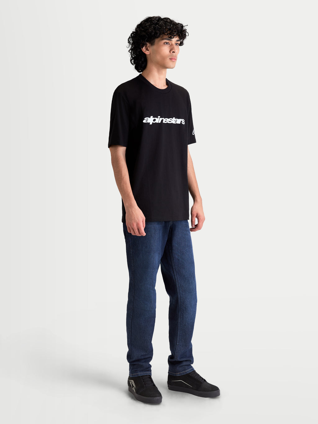 Alpinestars Race Wordmark CSF Tee, Casual Sportswear Short Sleeve T-Shirt for Men and Women, Black and White, featuring a white front wordmark logo and sleeve branding, on-model view, motorsport lifestyle apparel