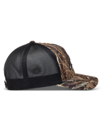 Alpinestars Thicket Realtree Trucker pet, camo en zwart, zijaanzicht met gebogen klep en ademende mesh achterkant.