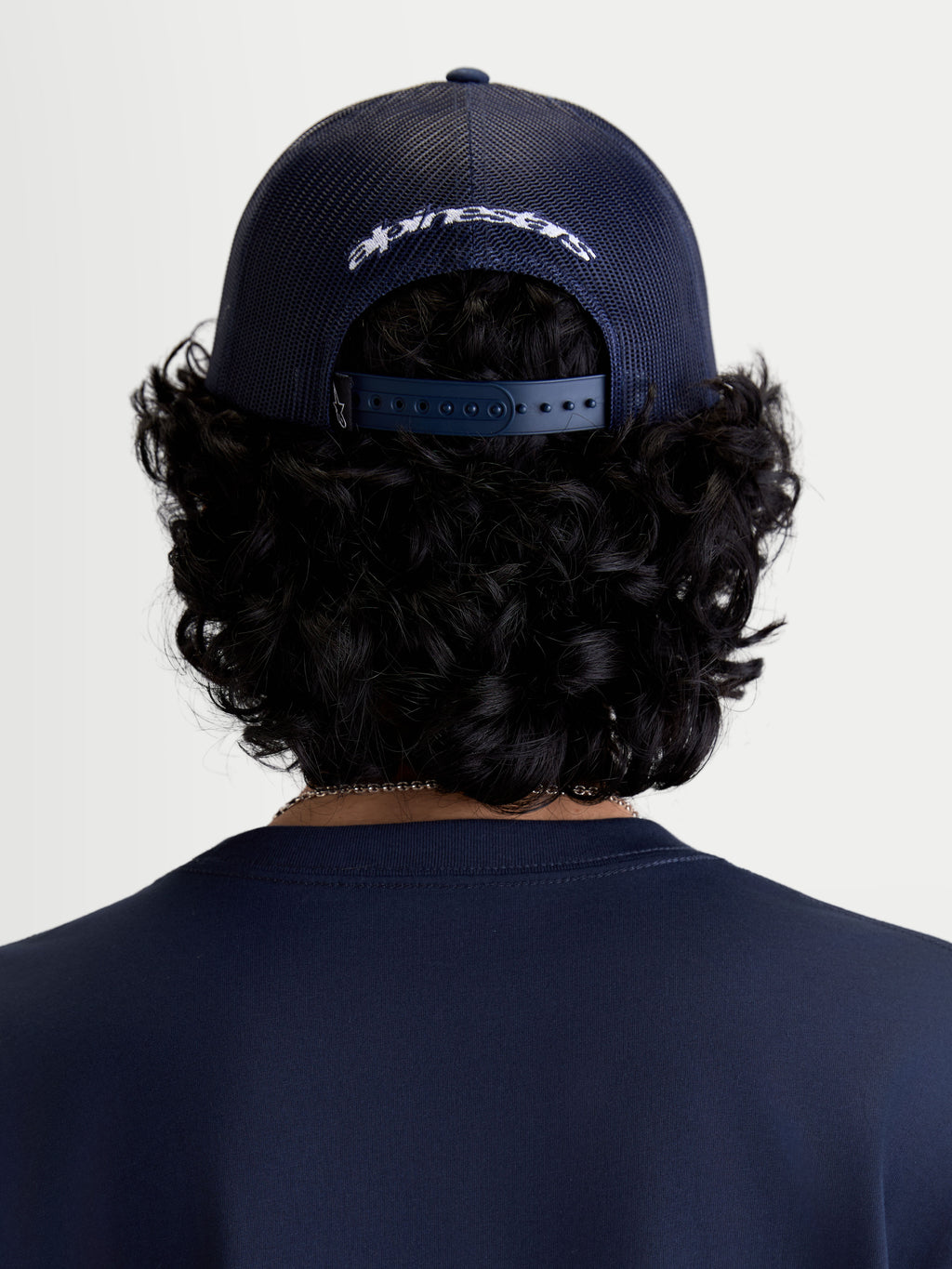 Alpinestars Meteorite Trucker Hat, Sportswear Casual Headwear, Rear View on Model, Navy Blue, Poly Mesh Back and Adjustable Snapback Closure with White Embroidered Branding