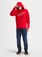 Alpinestars Ageless Zip V3 hoodie, heren sportswearfleece met volledige rits, rood en wit, op model, voorzien van een wit Alpinestars-logo op de borst, capuchon met trekkoorden en geribde manchetten, ideaal voor motorsportfans.