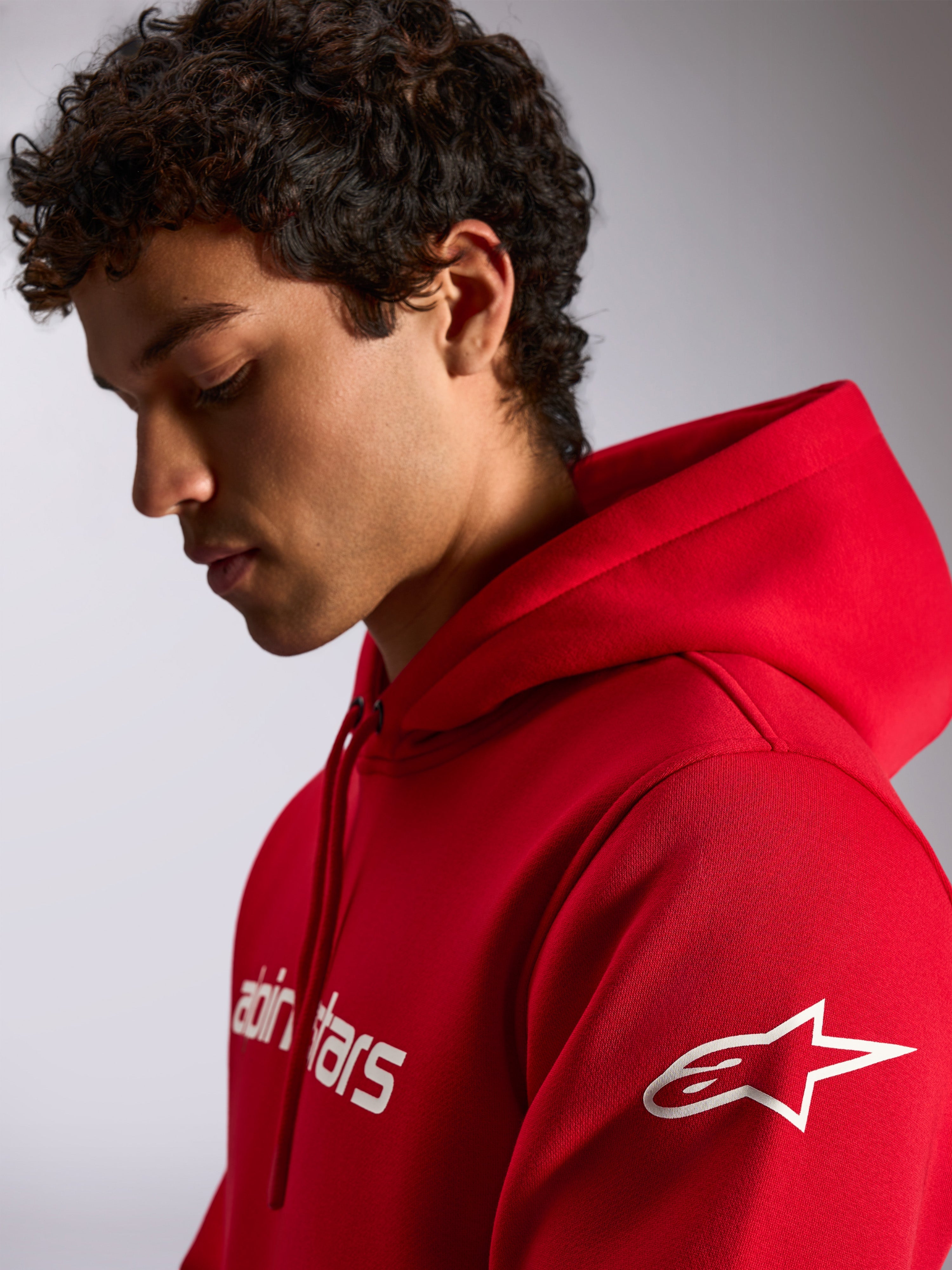 Alpinestars Linear Wordmark V3 Hoodie, Red, casual streetwear, white Alpinestars wordmark on chest and white Ageless star logo on sleeve, drawstring hood, worn by male model