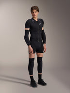 Alpinestars A-Motion Plasma Protection Boxers, Black, worn as part of a complete mountain bike protective base layer including a short-sleeve padded jacket, elbow guards, and knee guards, sleek athletic design for off-road performance