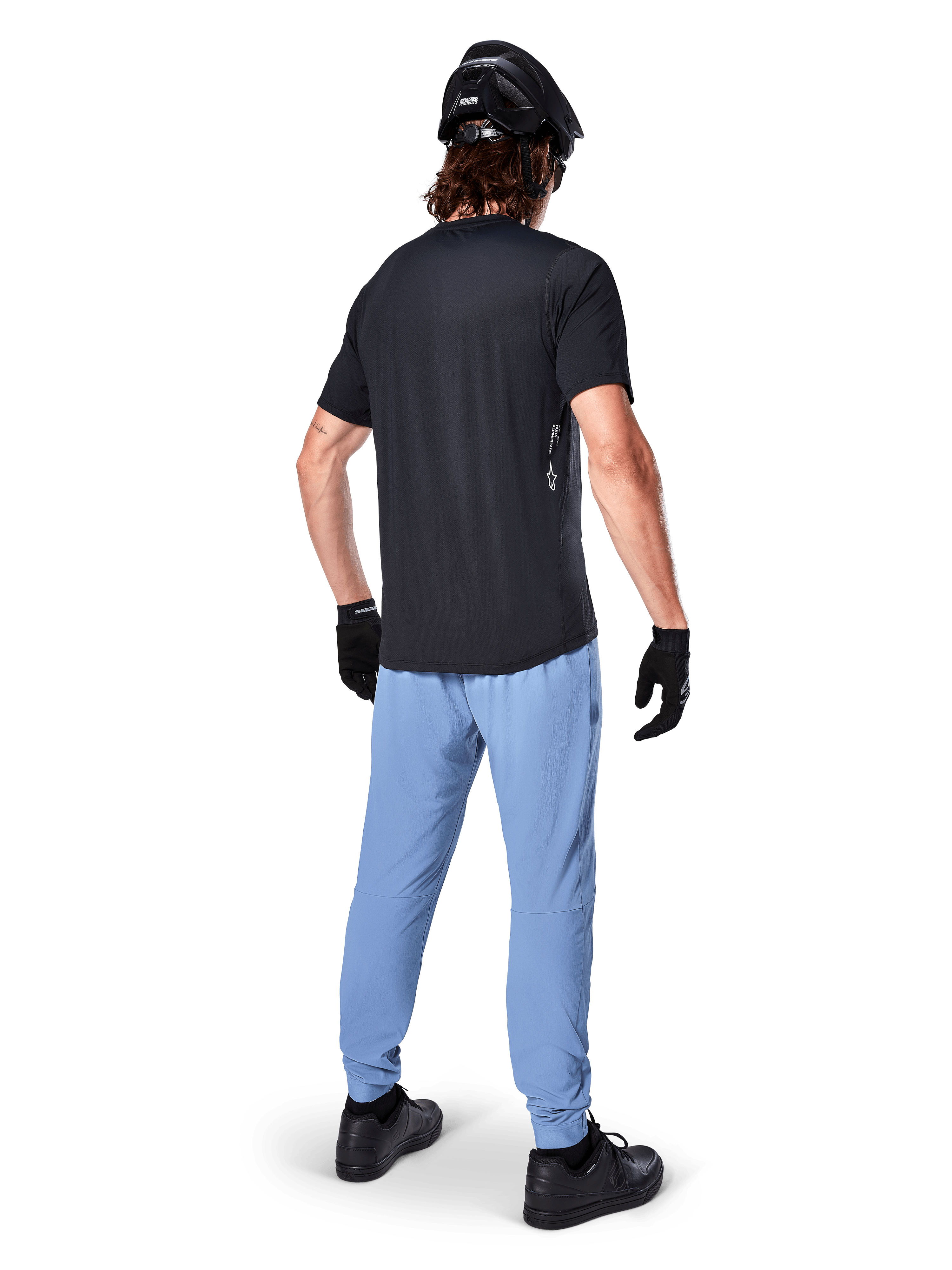 Alpinestars A-Dura Pants, MTB Pants, Infinity Blue, rear view on model wearing a black t-shirt and black cycling helmet, featuring durable 2-way stretch fabric and elasticated cuffs, performance gear for mountain biking