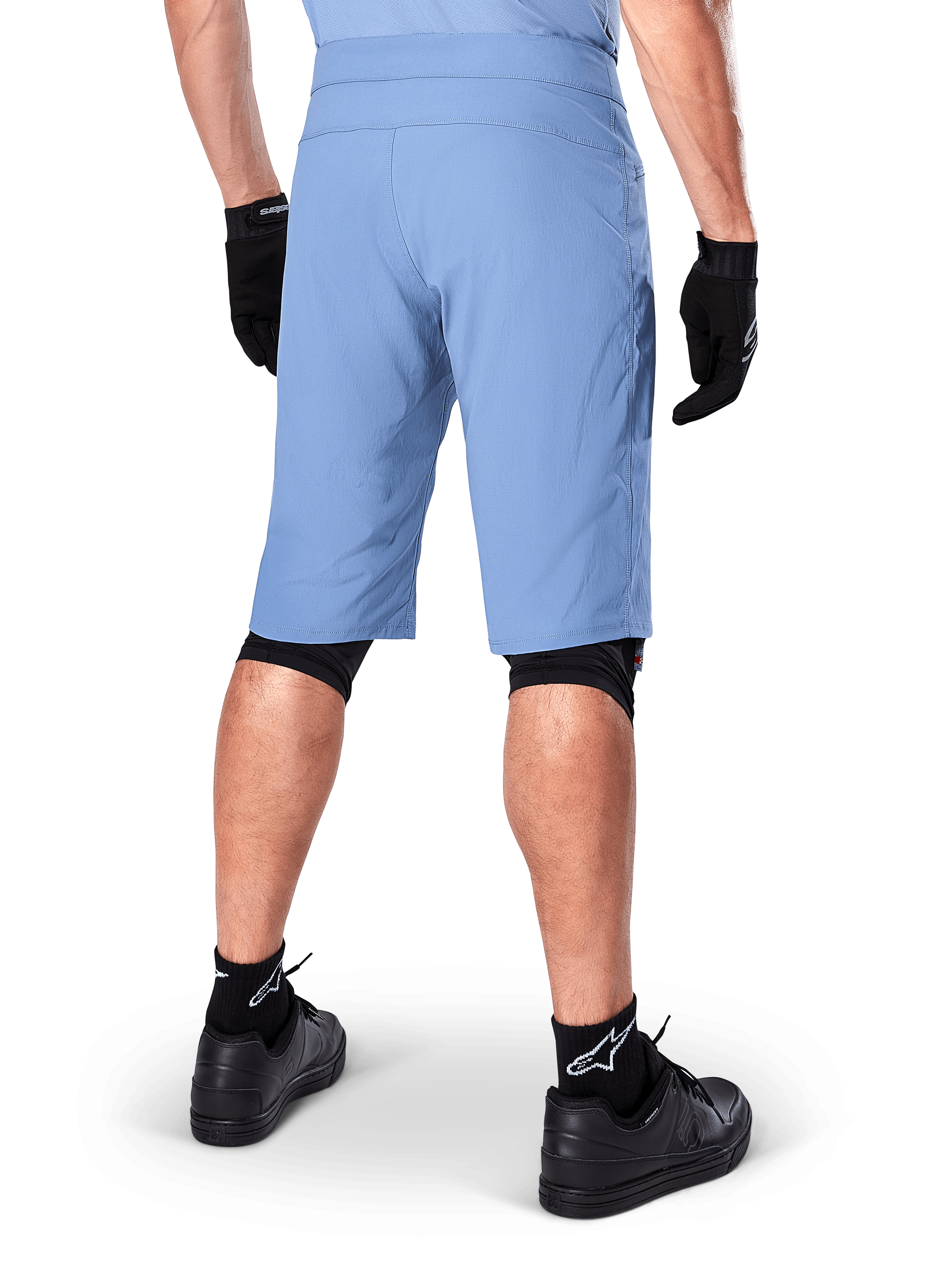 Alpinestars A-Dura Shorts, Infinity Blue mountain bike shorts, back view, paired with black gloves, knee liners, and black socks with white star logo, durable stretch material for off-road cycling