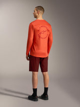 Oranje A-Dura Air jersey met lange mouwen en ruggrafiek, bordeauxrode A-Dura Ride shorts, performance MTB-kleding.