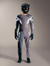 Alpinestars A-Supra Elite MTB gear in faded gray, featuring performance jersey and pants with bold white logos.