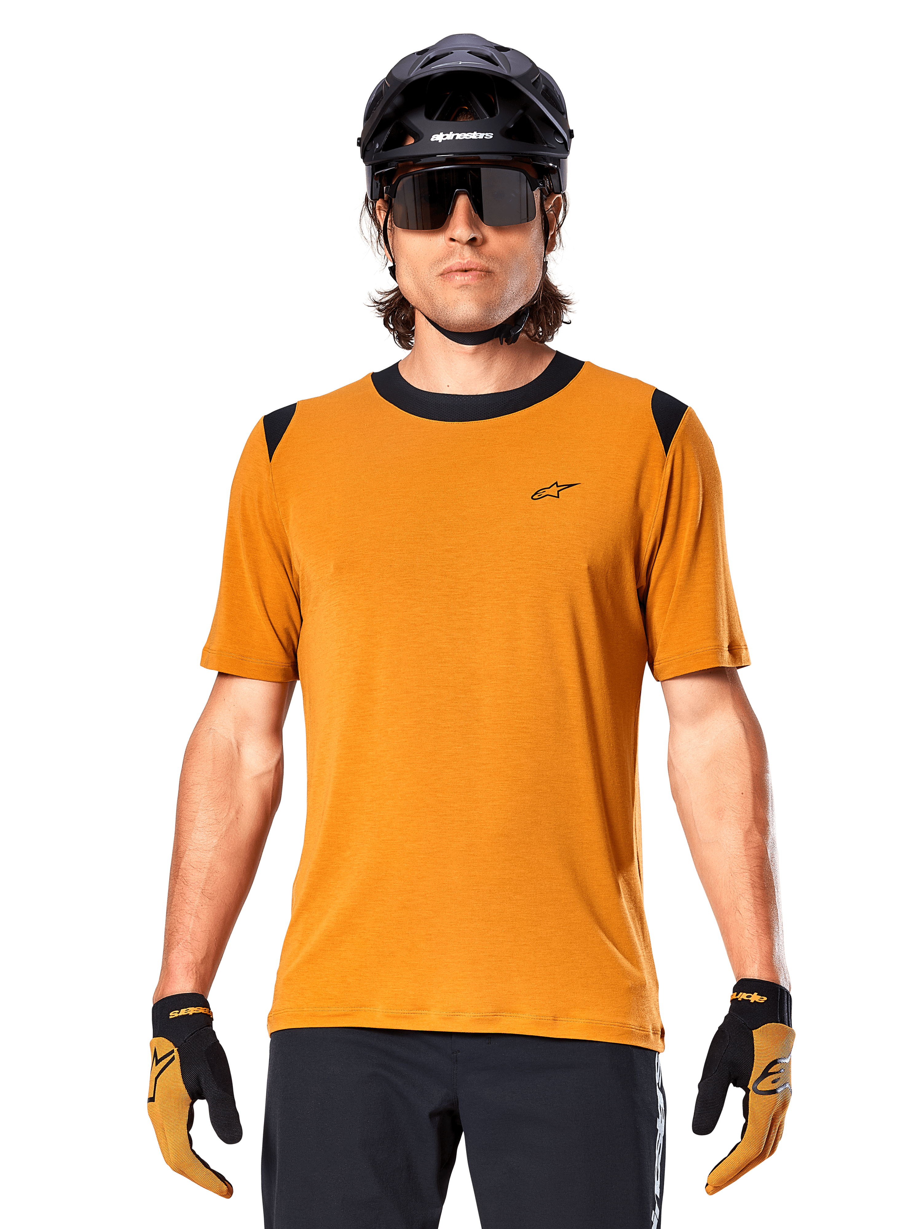 Alpinestars A-Dura Dri Wool Short Sleeve Jersey, Dark Gold, worn with black MTB helmet, sunglasses, and gloves, featuring black collar and shoulder panels, breathable drirelease wool blend for mountain biking