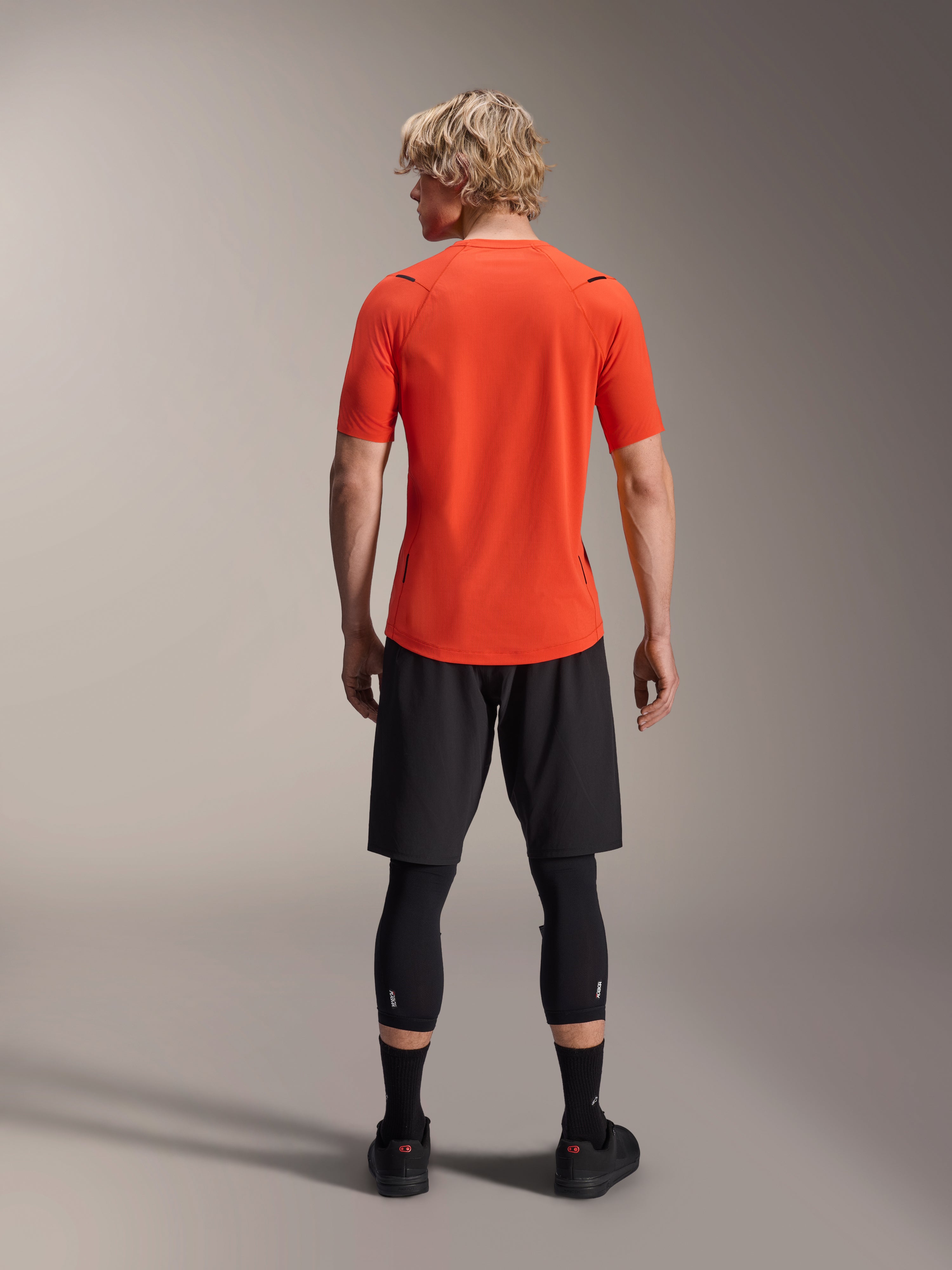 Alpinestars A-Aria Astar Jersey, MTB-jersey met korte mouwen, Spicy Orange, achteraanzicht met prestatiepasvorm en verlengde achterzijde, gecombineerd met zwarte fietsshort en leggings