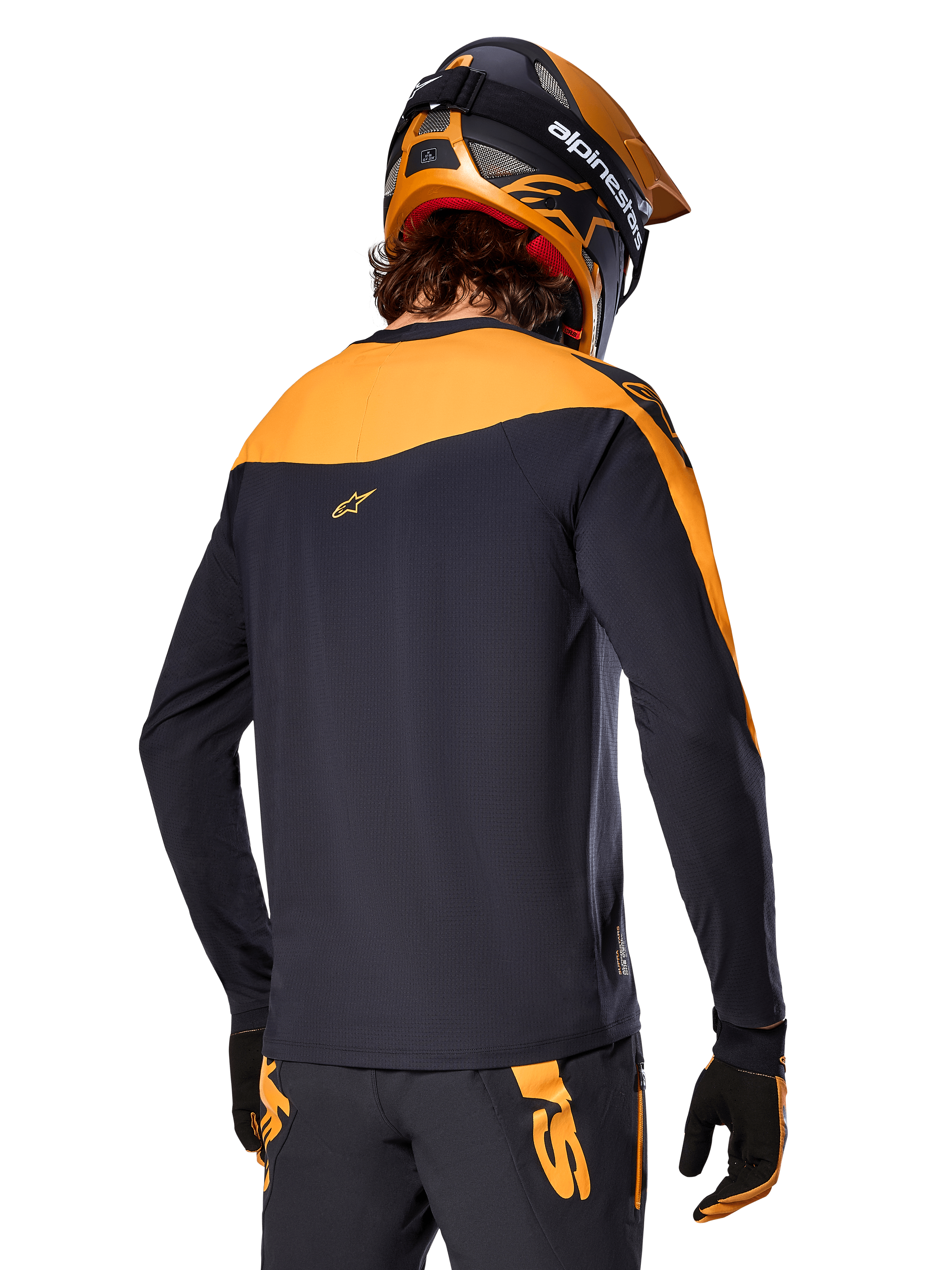 Alpinestars A-Supra Race Jersey - Long Sleeve, Black and Orange, back view of rider wearing matching helmet and mountain bike pants, performance fit with micro-perforated texture, professional MTB racing gear