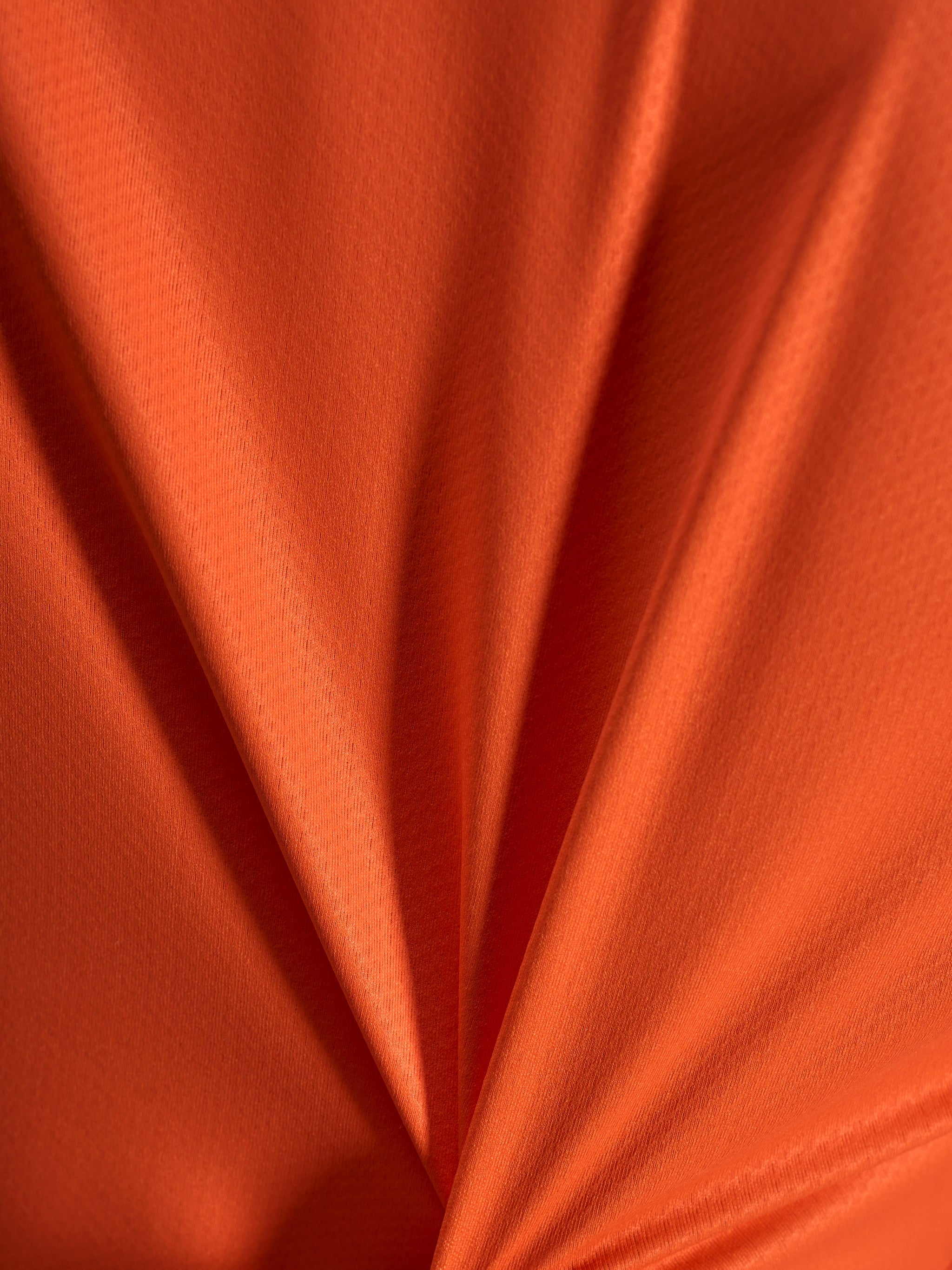 Oranje jacquardstof detail van de Alpinestars Stella A-Dura Ride Jersey met een lichtgewicht en rekbare textuur.