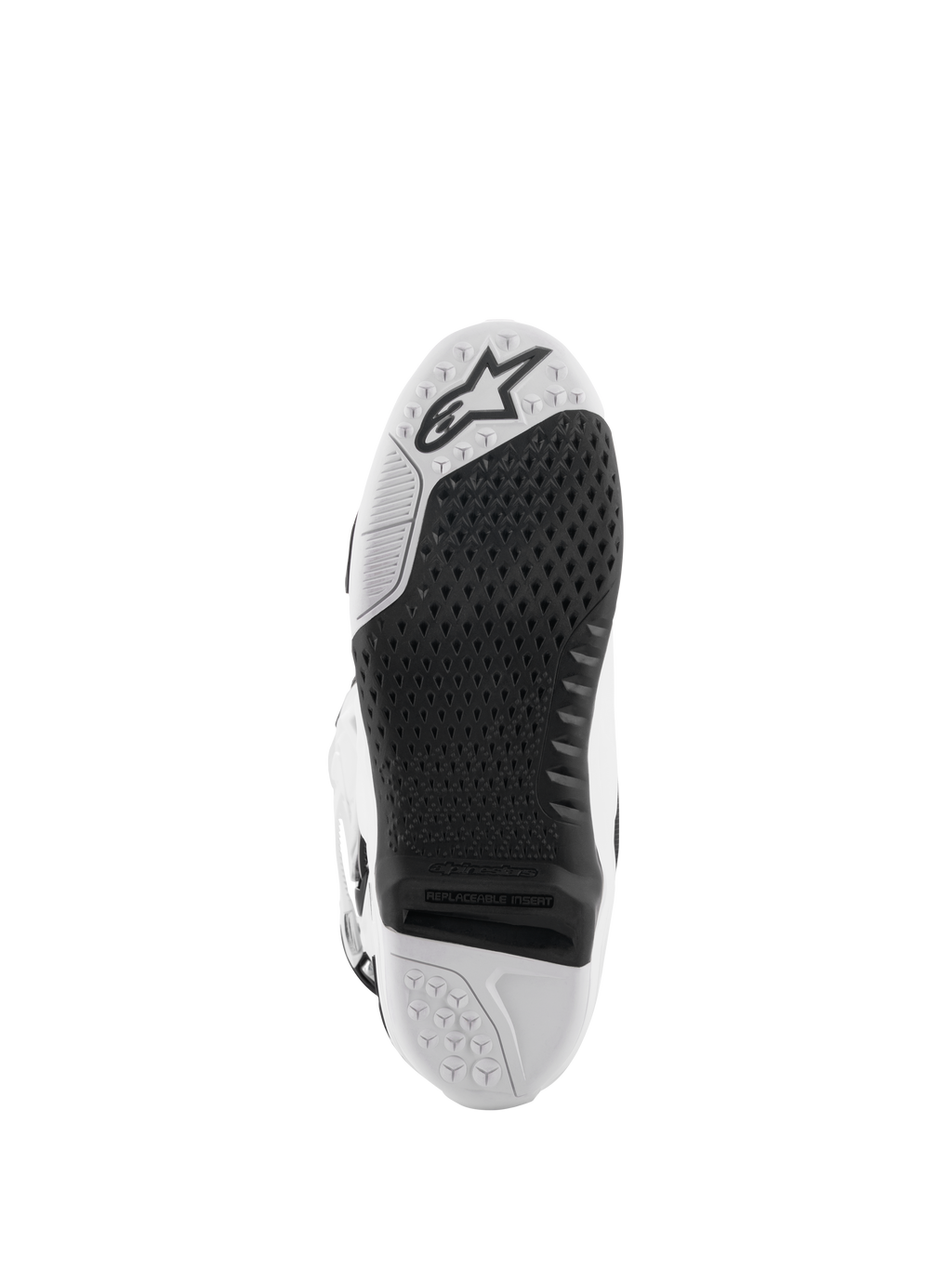 Alpinestars Tech 10 laarzen, motorcrosslaarzen, wit en zwart, onderaanzicht van de zool met een getextureerd grippatroon, Alpinestars-logo en een vervangbaar centraal inzetstuk voor off-road racen.