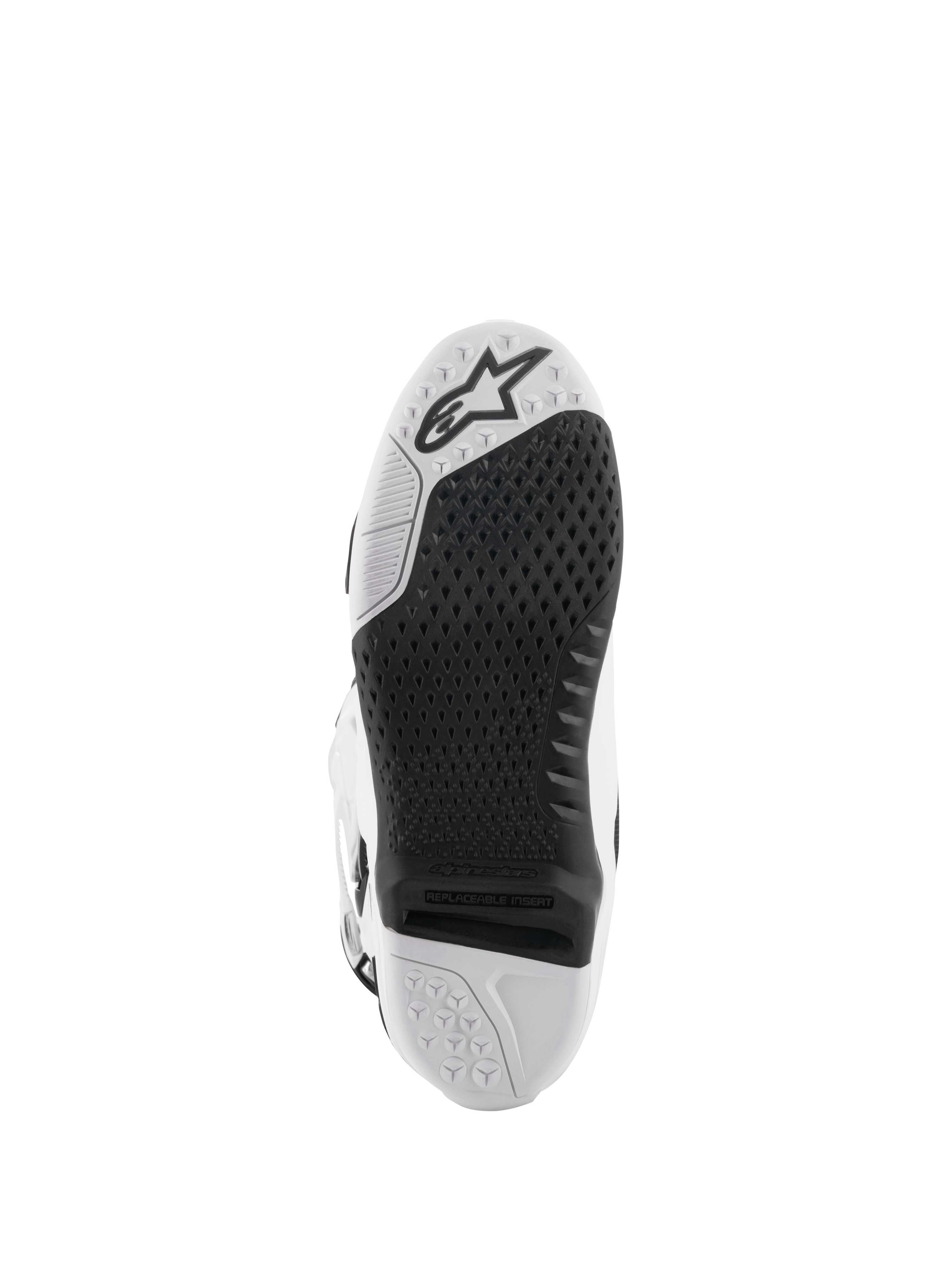 Alpinestars Tech 10 laarzen, motorcrosslaarzen, wit en zwart, onderaanzicht van de zool met een getextureerd grippatroon, Alpinestars-logo en een vervangbaar centraal inzetstuk voor off-road racen.