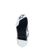 Alpinestars Tech-10 laarzen, motocrosszool in zwart en wit met een vervangbaar grip-inzetstuk en ster-logo.