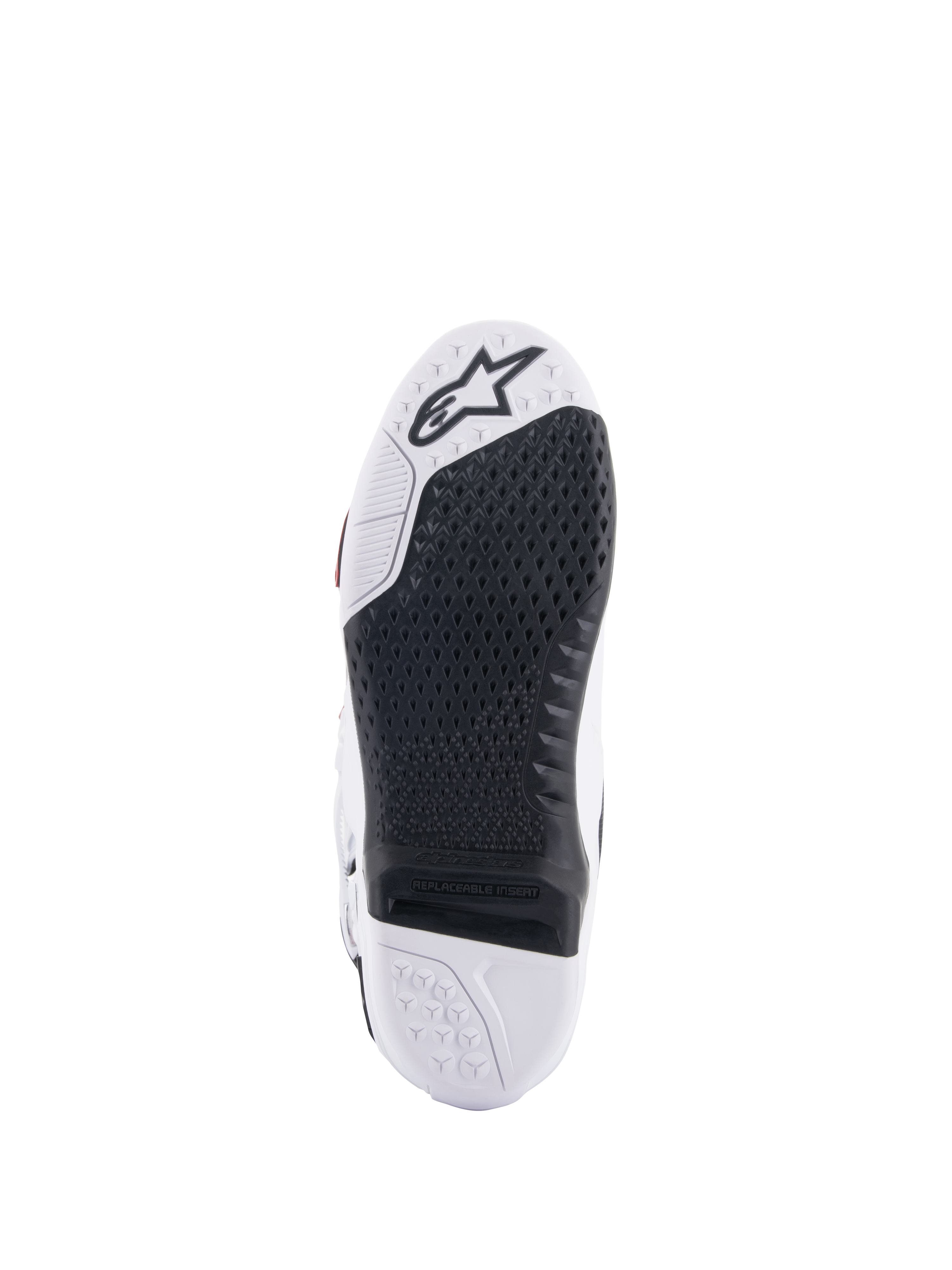 Alpinestars Tech 10 Supervented laarzen, wit en zwart zoolaanzicht, voorzien van een uitgebreid honingraat gripontwerp, zwarte vervangbare centrale insert, witte neus met Alpinestars sterlogo, geoptimaliseerd voor controle op de motorcross voetsteun.