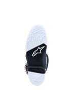 Alpinestars Tech 7 motorlaarzen, wit en zwarte dubbel samengestelde rubberen zool met rode slijtage-indicator, ontworpen voor motorcross en off-road rijden.