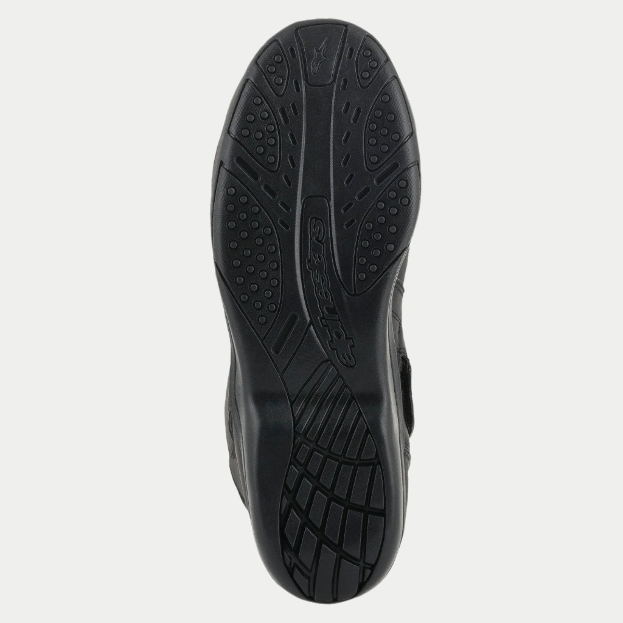 Alpinestars Origin Drystar® laarzen, zwart, detailweergave van de rubberen buitenzool, getextureerd grippatroon met logo in reliëf, duurzame zool voor motortouring