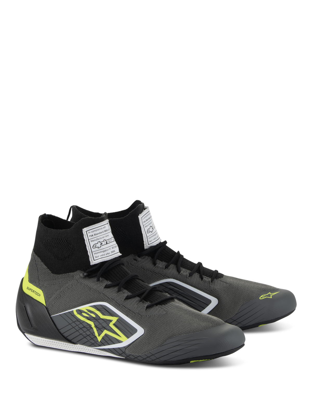 Alpinestars Supertech schoenen, autosport schoeisel, Cool Gray en zwart met fluogeel accenten, voorzien van een gebreid aramide bovenwerk, carbon hielkap en witte FIA-certificeringslabels op de tong, professioneel motorsportontwerp