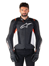 Alpinestars Missile V3 Leather Jacket, Black White and Red Fluo, premium racing sport jacket with bovine leather, featuring white chest logo and Alpinestars branding on sleeves, worn with black motorcycle gloves and pants