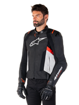 Alpinestars Missile V3 Leather Jacket, Black White and Red Fluo, racing sport motorcycle jacket worn by a model with black gloves and pants, featuring perforated leather panels and bold Alpinestars branding