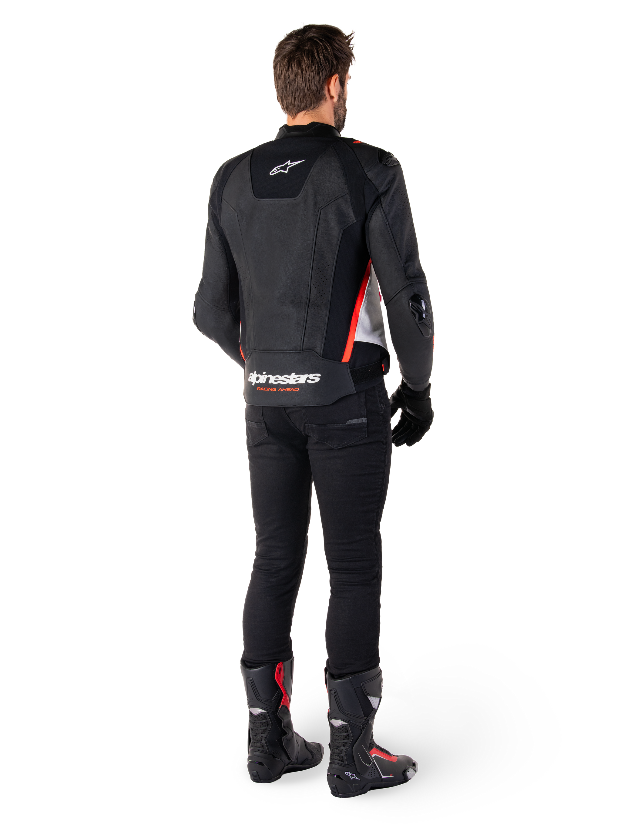 Alpinestars Missile V3 Leather Jacket in Black White Red Fluo, back view on a male rider, featuring Alpinestars branding on the upper and lower back, paired with black pants and motorcycle boots, racing-inspired leather sport jacket.