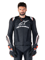 Alpinestars Missile V3 Ignition Leather Jacket, Black with white and red accents, worn by a male model with matching racing gloves and pants, MotoGP-derived sport motorcycle jacket with bold branding