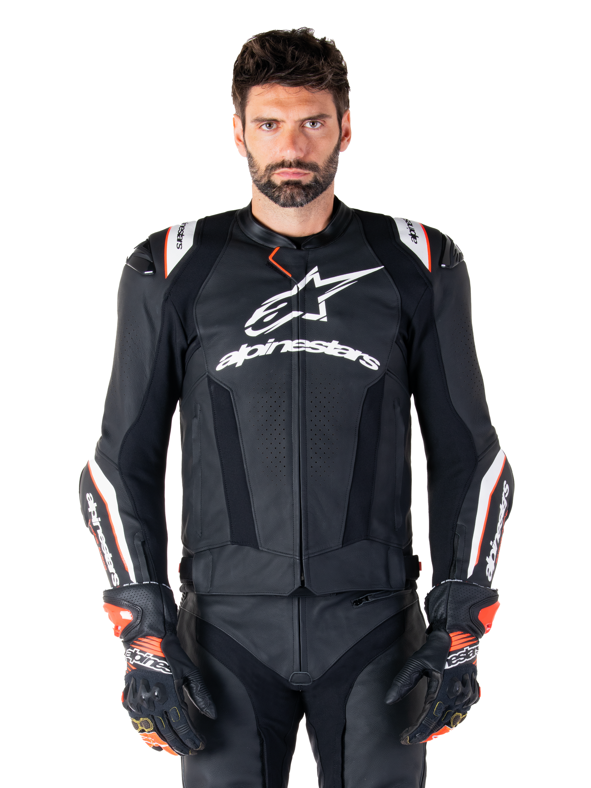 Alpinestars Missile V3 Ignition Leather Jacket, Black with white and red accents, worn by a male model with matching racing gloves and pants, MotoGP-derived sport motorcycle jacket with bold branding
