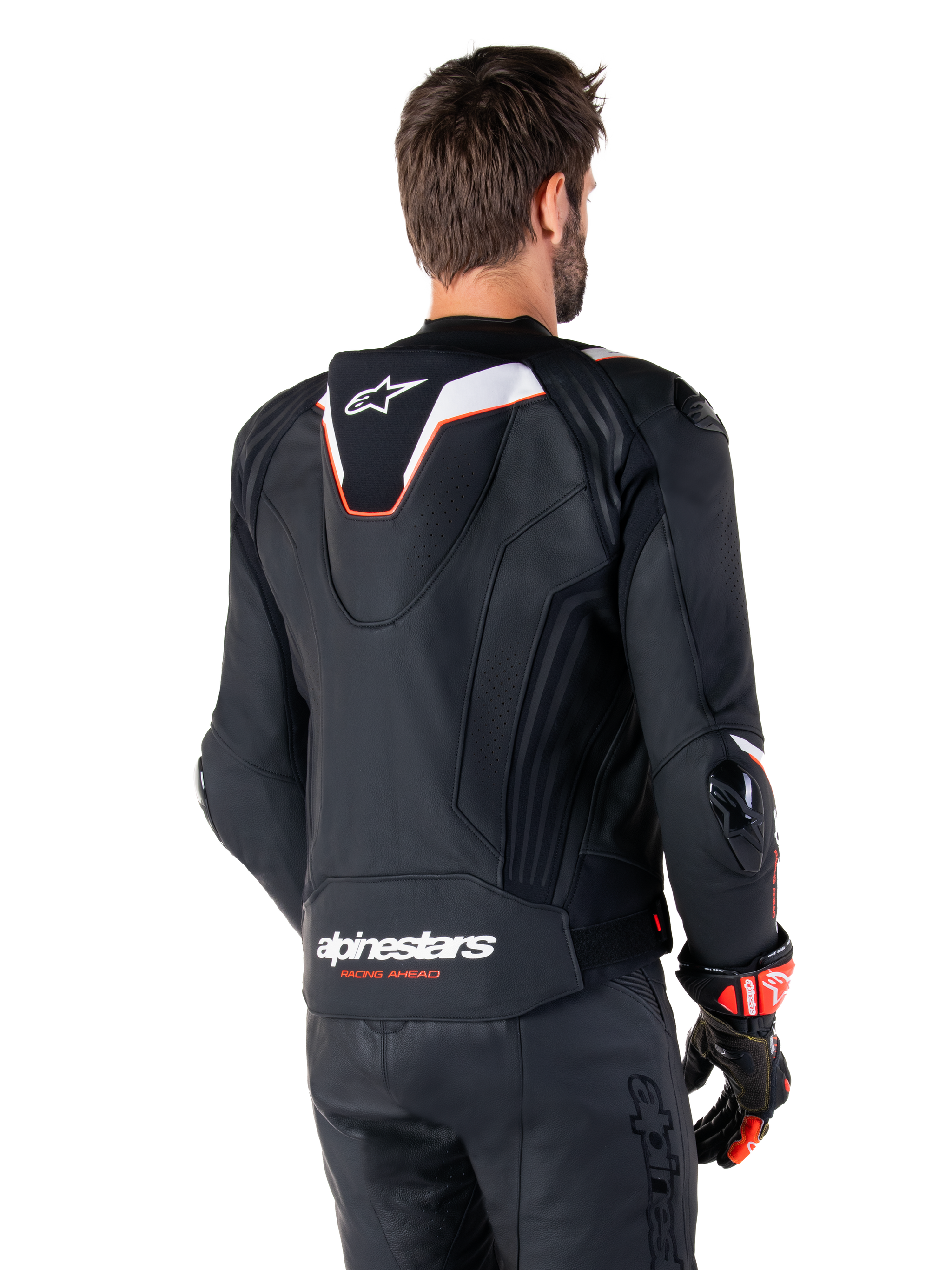 Alpinestars Missile V3 Ignition Leather Jacket, Rear View, Black with White and Red accents, featuring a slim sport Aero-hump and Alpinestars branding, worn with matching leather pants and racing gloves