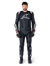 Male rider wearing the Alpinestars Missile V3 Ignition Leather Jacket in Black, paired with matching leather pants, gloves, and boots, featuring white Alpinestars branding and red accents, designed for professional racing performance.