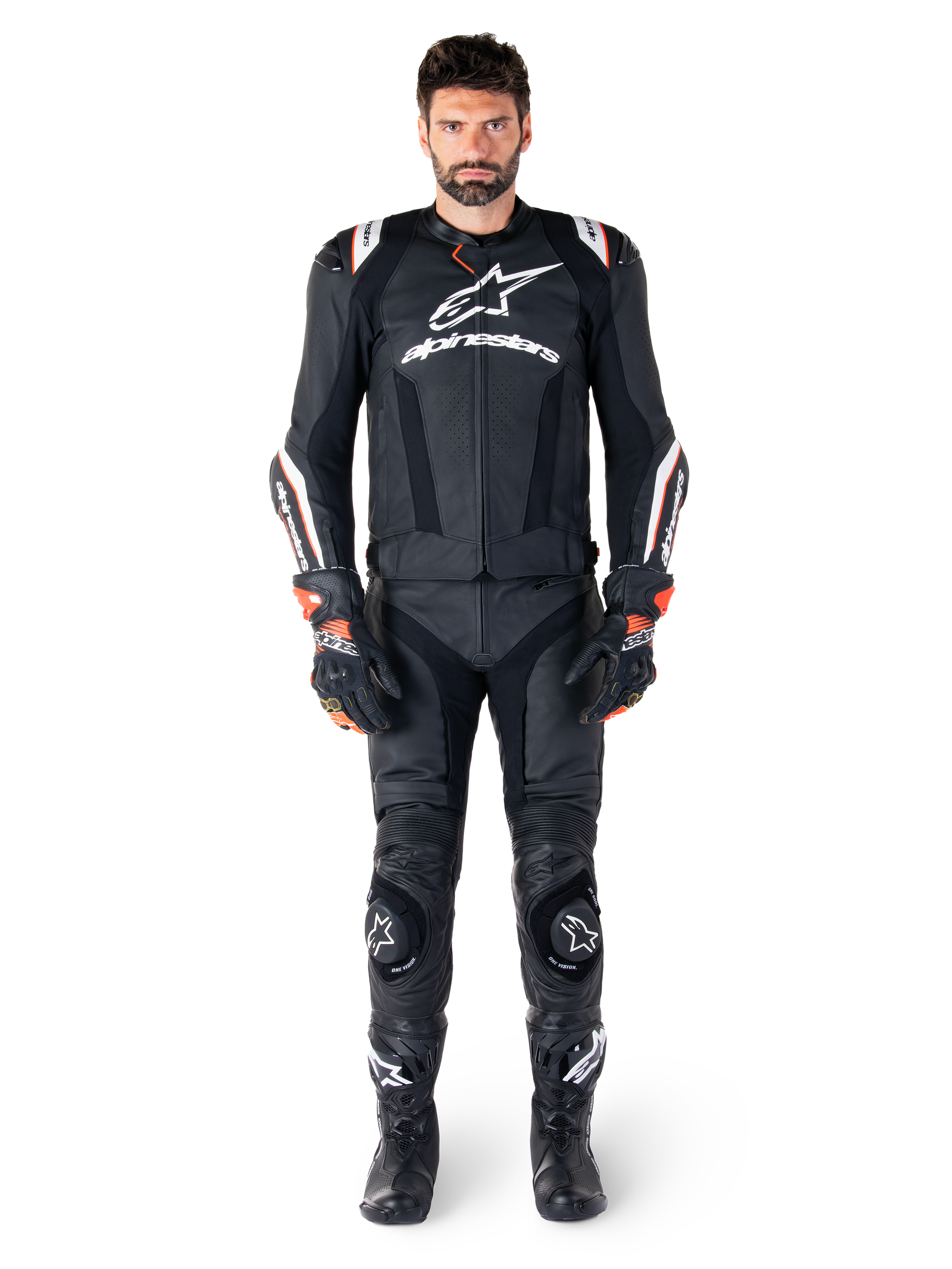 Male rider wearing the Alpinestars Missile V3 Ignition Leather Jacket in Black, paired with matching leather pants, gloves, and boots, featuring white Alpinestars branding and red accents, designed for professional racing performance.