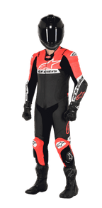 Motorcycle rider wearing the Alpinestars Missile V2 Ward 1-Piece Leather Suit, Black Red Fluo and White colorway, complete with a black helmet, black racing gloves, and black boots, designed for high-performance track racing