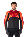 Alpinestars T-Jaws V4 Waterproof Jacket, sportieve textiele motorjas, zwart met felrode en donkerrode accenten, gedragen door een mannelijk model met bijpassende handschoenen, technische motoruitrusting met opvallend sterlogo op de borst.