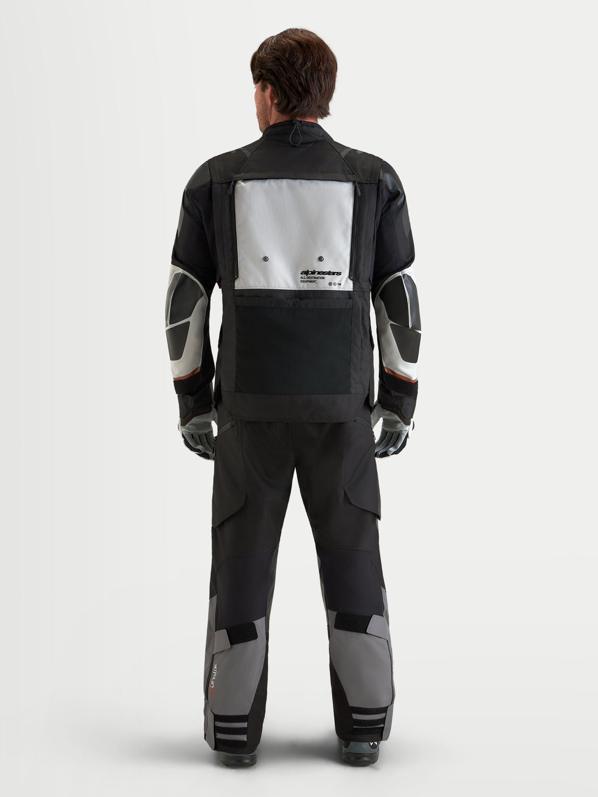 Alpinestars Harok V2 Drystar Gear Set, motorcycle touring jacket and pants in black and grey, rear view of a model wearing waterproof all-weather adventure riding apparel
