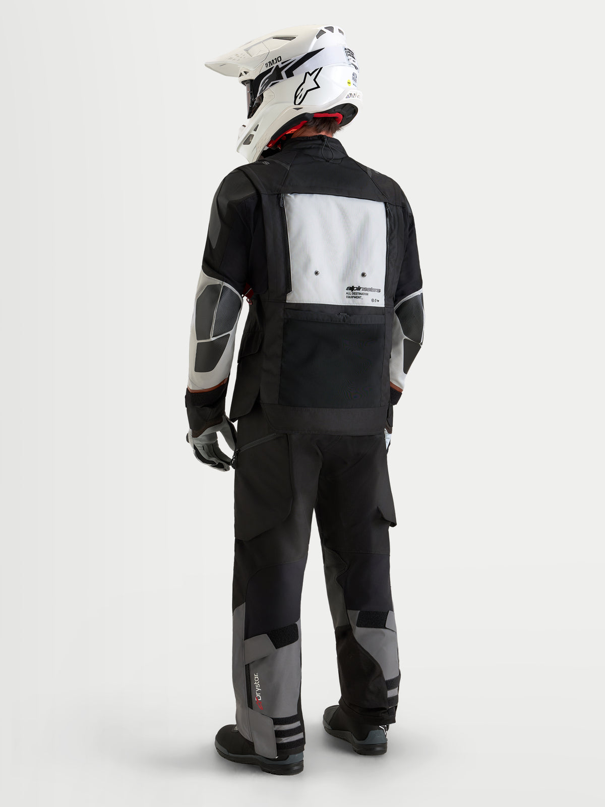 Alpinestars Harok V2 Drystar Gear Set, motorcycle touring jacket and pants in black and light gray, rear view on a model wearing matching waterproof textile riding apparel and a white helmet