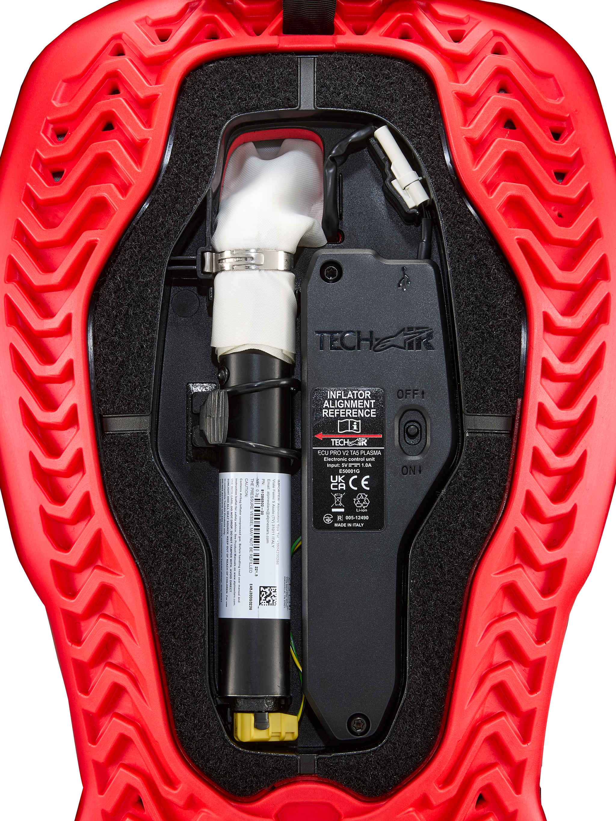Tech-Air® 5 Plasma Airbag Replacement Canister, red and black, close-up view showing cylindrical inflator with white top, silver clamp, ON/OFF switch, technical components, wires, and wavy ribbed texture outer shell