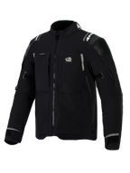 Alpinestars Andes Pro Drystar® XF Jacket, Black and Dark Gray adventure motorcycle jacket, front angled view, featuring 'ALL TERRA' chest logo, reflective branding on shoulders, multiple waterproof zippered pockets, and adjustable sleeve cuffs.
