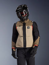 Alpinestars Andes Pro Drystar® XF Jacket, Adventure Touring Motorcycle Jacket, Walnut Aluminum beige and brown with black panels and red accents, worn with a black Alpinestars helmet and goggles, technical outdoor motorcycle gear